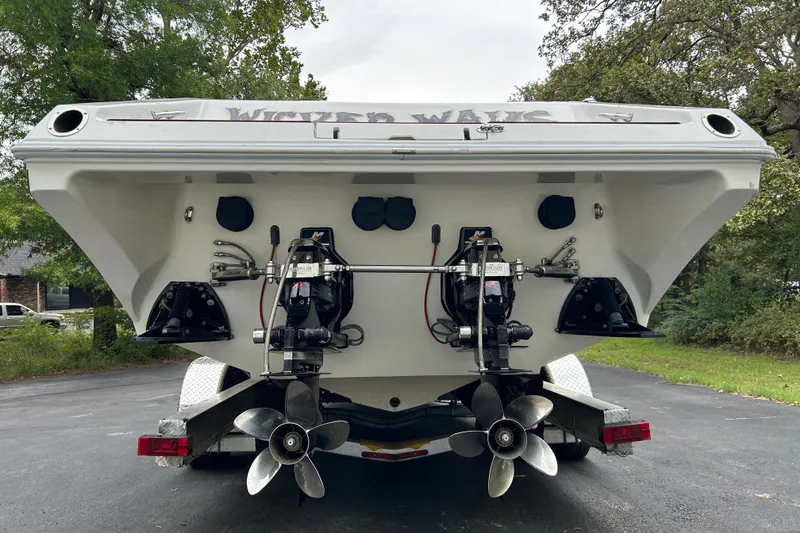 Slide: The Image of Rear view of a 2002 Fountain 38 Lightning boat on a trailer. - 14