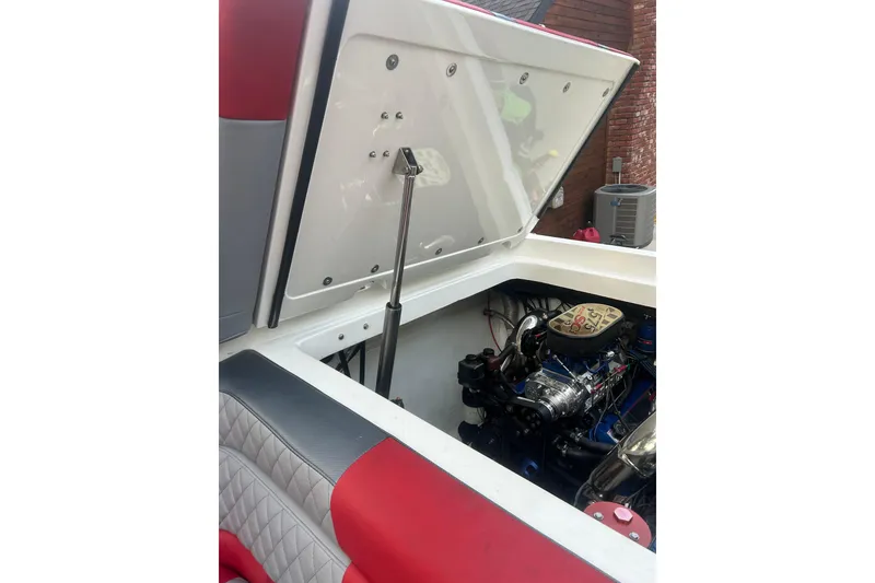 Slide: The Image of Open engine compartment of 2002 Fountain 38 Lightning boat, showcasing detailed engine components. - 23