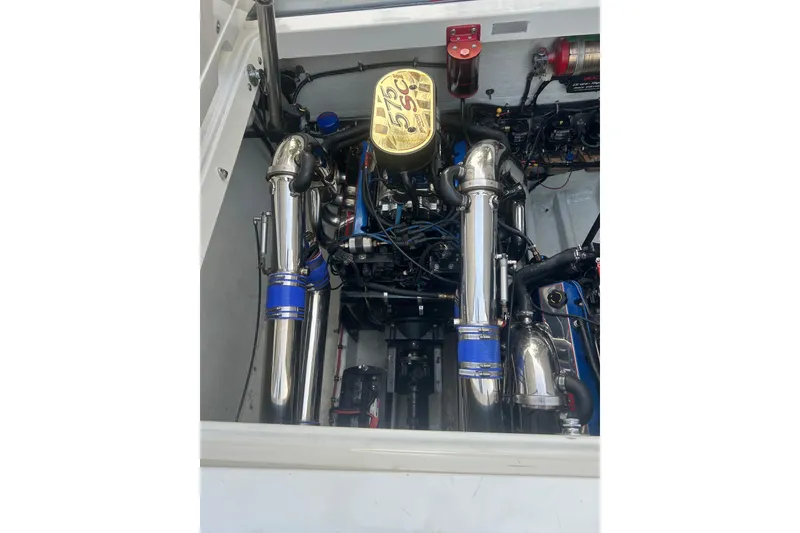 Slide: The Image of Engine compartment of a 2002 Fountain 38 Lightning boat, featuring polished components. - 26