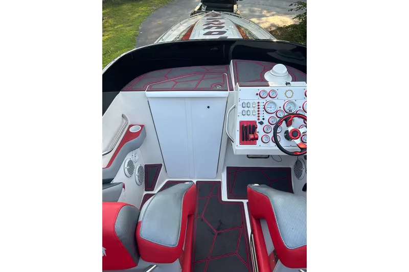 Slide: The Image of Cockpit of 2002 Fountain 38 Lightning boat with red and gray seating, detailed dashboard. - 29
