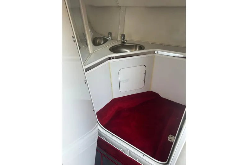 Slide: The Image of Interior of 2002 Fountain 38 Lightning boat with red carpet and stainless steel sink. - 32