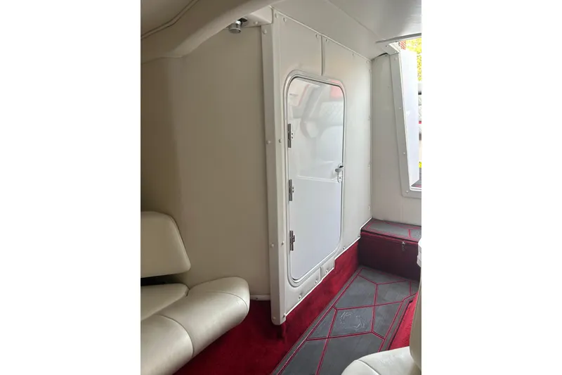 Slide: The Image of Interior of 2002 Fountain 38 Lightning boat with white seating and red carpet. - 33