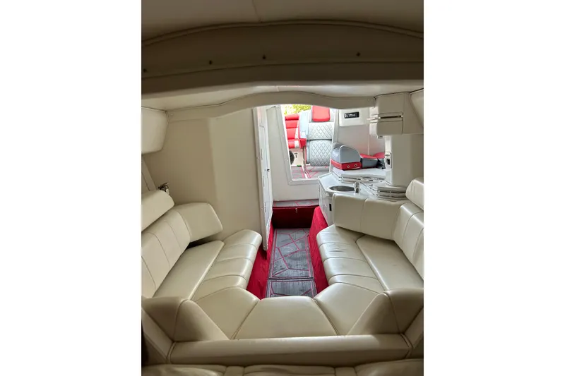 Slide: The Image of Interior of a 2002 Fountain 38 Lightning boat with white seating and red accents. - 38