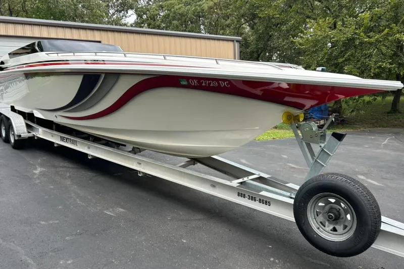 Slide: The Image of 2002 Fountain 38 Lightning boat on trailer, featuring sleek design and vibrant red accents. - 4