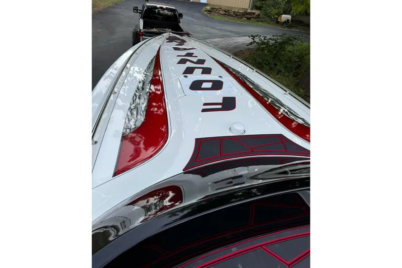 Slide: The Image of 2002 Fountain 38 Lightning boat with bold red and black graphics on trailer. - 42
