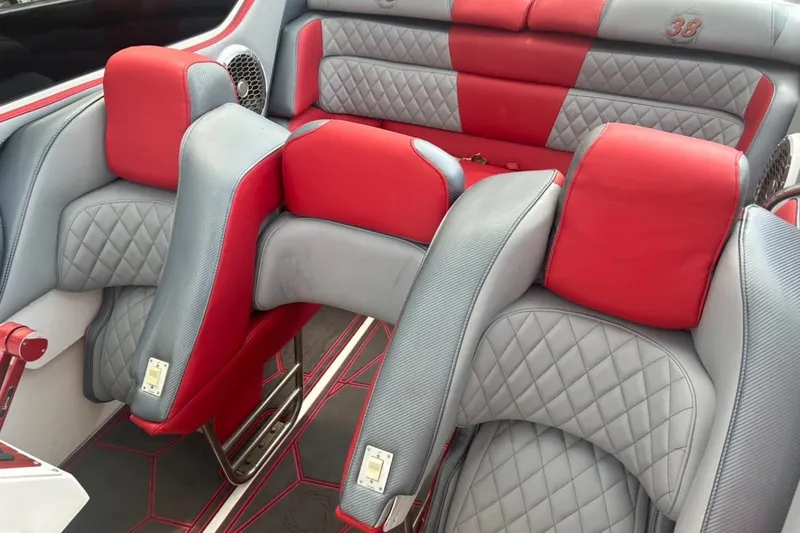 Slide: The Image of Luxurious red and gray interior of a 2002 Fountain 38 Lightning boat, featuring quilted seats. - 46