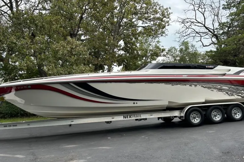 Slide: The Image of 2002 Fountain 38 Lightning speedboat on trailer, featuring sleek design and vibrant graphics. - 5