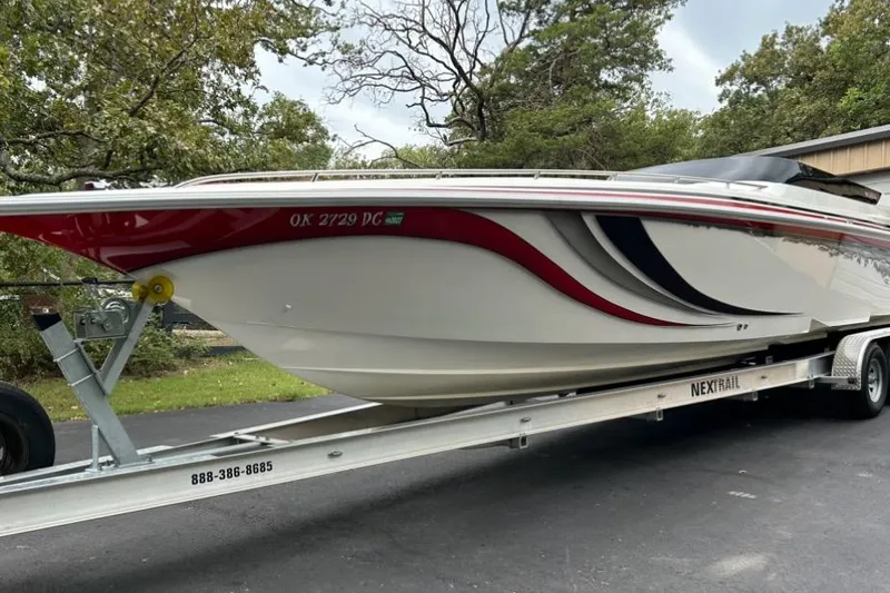 Slide: The Image of 2002 Fountain 38 Lightning boat on trailer, featuring sleek design and vibrant graphics. - 6
