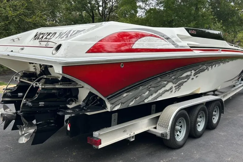 Slide: The Image of 2002 Fountain 38 Lightning boat on trailer, featuring sleek red and white design. - 9