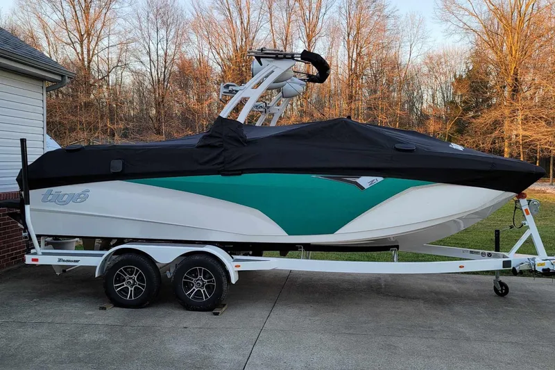 Slide: The Image of 2022 Tigé Z1 boat on trailer with cover, parked in driveway. - 4