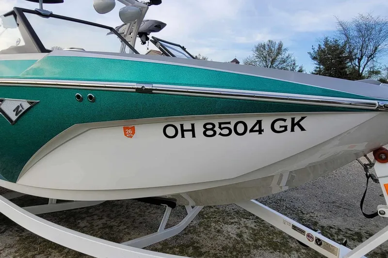 Slide: The Image of 2022 Tigé Z1 boat with registration OH 8504 GK, teal and white color scheme. - 6