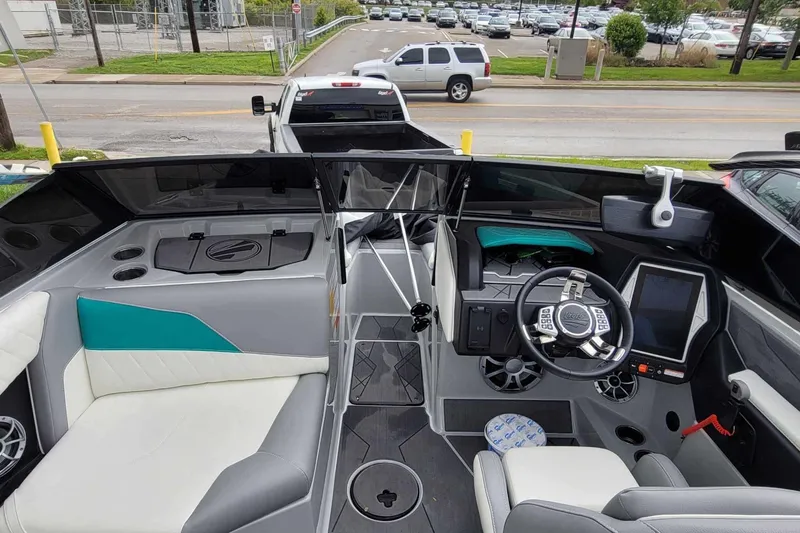 Slide: The Image of 2022 Tigé Z1 boat interior with modern dashboard and seating, parked on a trailer. - 8