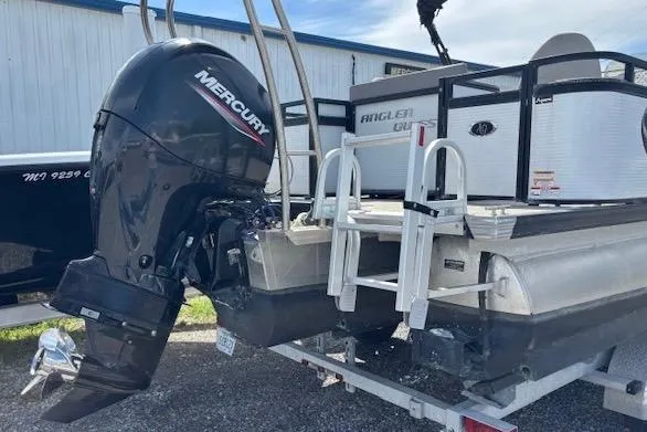 Slide: The Image of 2022 Angler Quest 26 All Sport boat with Mercury outboard motor, docked outdoors. - 3