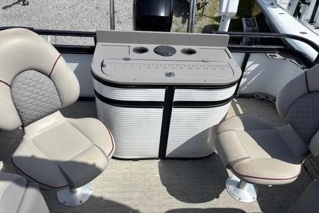 Slide: The Image of 2022 Angler Quest 26 All Sport boat interior with seating and storage unit. - 6