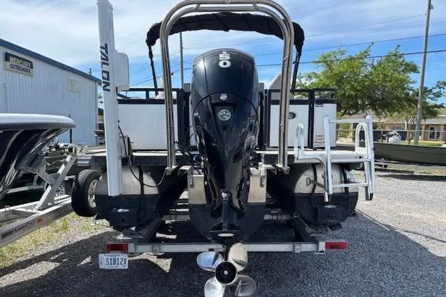 Slide: The Image of 2022 Angler Quest 26 All Sport boat with powerful outboard motor, parked on gravel. - 7