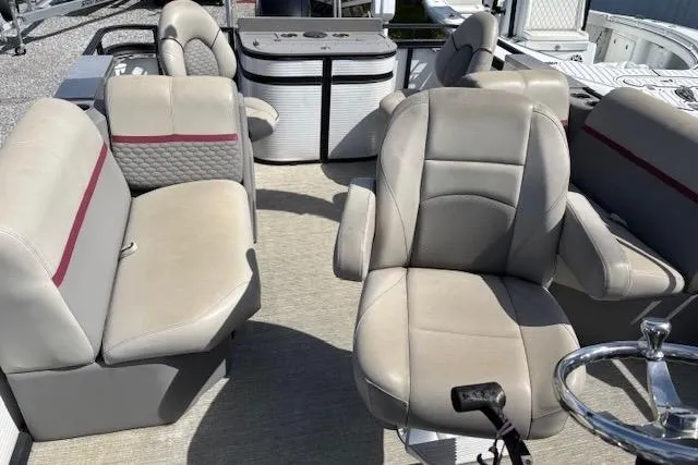 Slide: The Image of 2022 Angler Quest 26 All Sport boat interior with beige seating and steering wheel. - 8