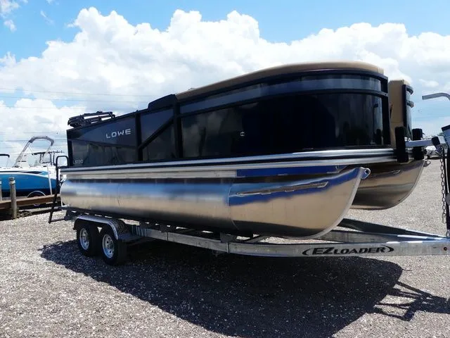 The Image of Lowe LS 190 pontoon boat 2026 on trailer, blue sky. - 1