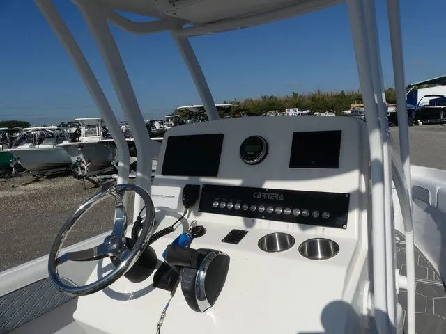 Slide: The Image of 2018 Carrera Sport Fishing boat console with controls and instruments. - 28