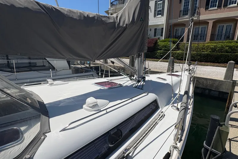 Slide: The Image of 2008 Wauquiez Centurion 40s sailboat docked, showcasing sleek deck design and covered sails. - 14