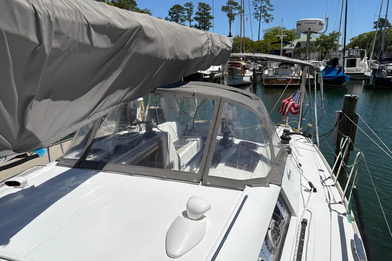 Slide: The Image of 2008 Wauquiez Centurion 40s sailboat docked in a marina, featuring a covered cockpit. - 15