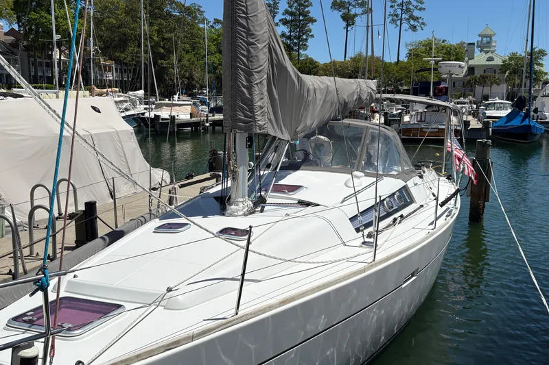 Slide: The Image of 2008 Wauquiez Centurion 40s sailboat docked at a marina, surrounded by other boats. - 4