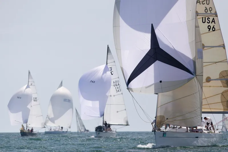 Slide: The Image of Sailboats racing on open water, featuring a 2008 Wauquiez Centurion 40s. - 54