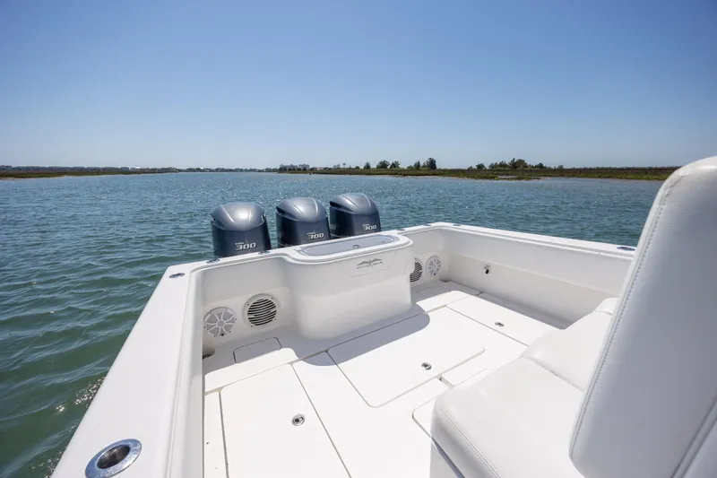 Slide: The Image of 2019 Invincible 36 Open Fisherman boat with triple 300 horsepower engines on calm water. - 11