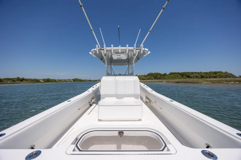 Slide: The Image of 2019 Invincible 36 Open Fisherman boat on calm water, clear sky background. - 12