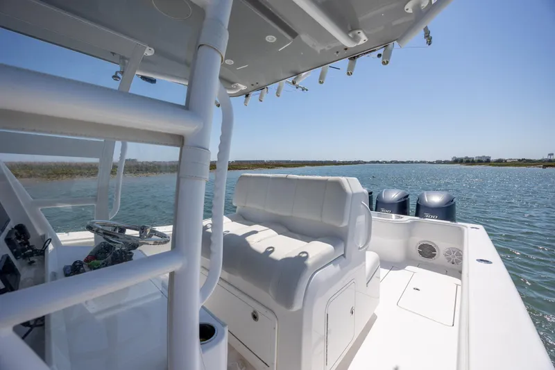 Slide: The Image of 2019 Invincible 36 Open Fisherman boat interior with dual engines on a sunny day. - 16