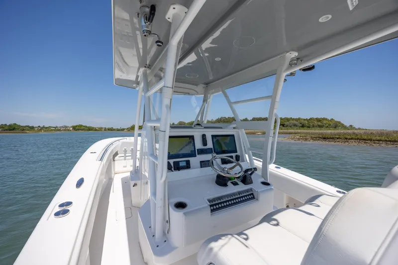 Slide: The Image of 2019 Invincible 36 Open Fisherman boat with modern helm, navigating calm waters. - 17