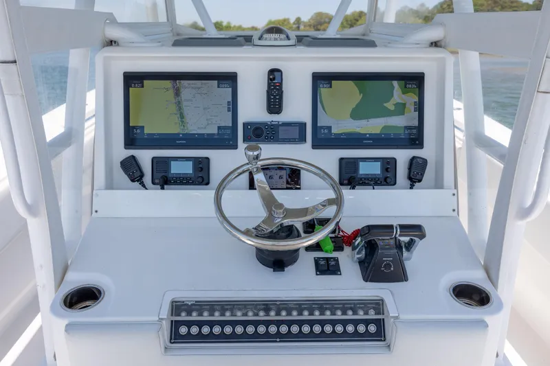 Slide: The Image of 2019 Invincible 36 Open Fisherman helm with dual navigation screens and controls. - 19