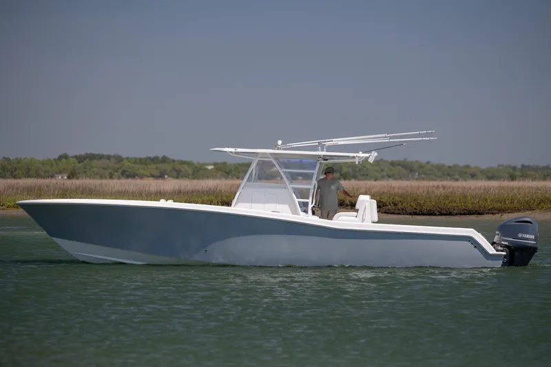 Slide: The Image of 2019 Invincible 36 Open Fisherman boat cruising on calm water. - 2