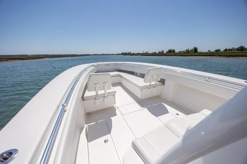 Slide: The Image of 2019 Invincible 36 Open Fisherman boat on calm water, clear sky background. - 20