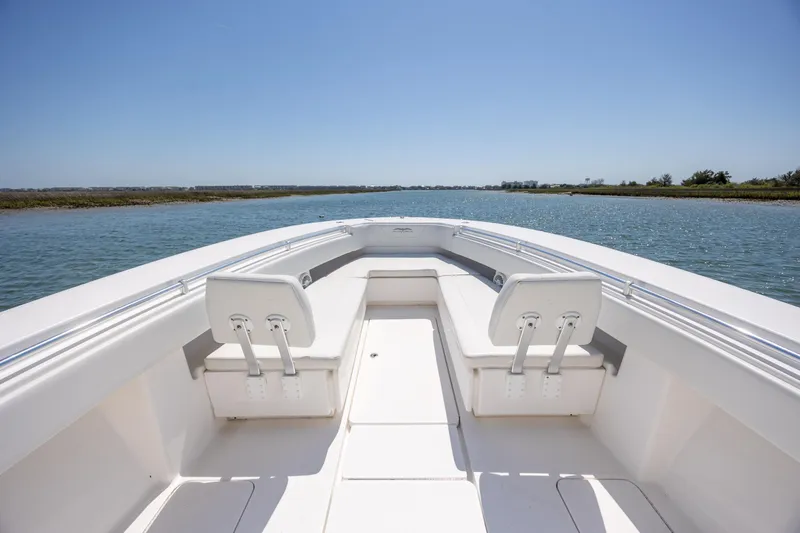 Slide: The Image of 2019 Invincible 36 Open Fisherman boat on calm water, clear sky. - 21