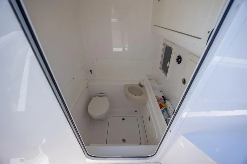 Slide: The Image of 2019 Invincible 36 Open Fisherman boat bathroom interior with toilet and sink. - 24