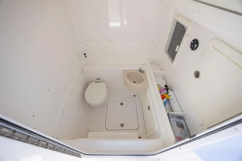 Slide: The Image of 2019 Invincible 36 Open Fisherman boat bathroom with toilet and sink. - 25