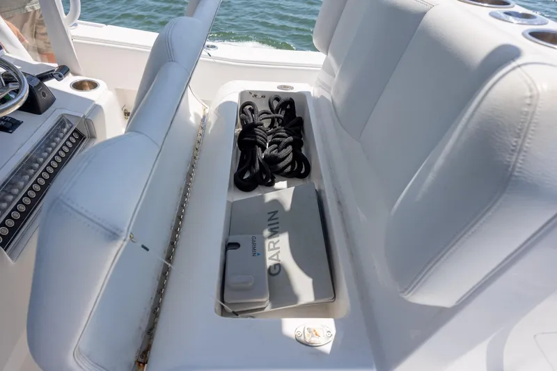 Slide: The Image of 2019 Invincible 36 Open Fisherman boat interior with Garmin equipment and storage compartment. - 26