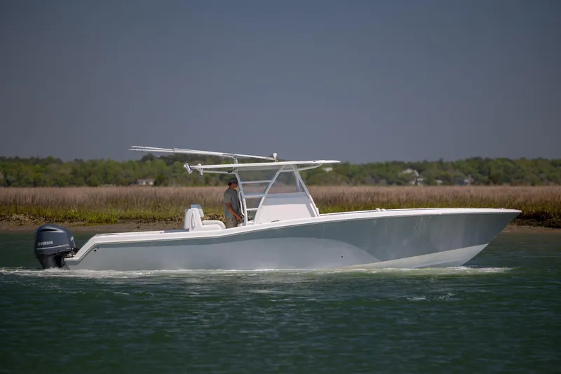 Slide: The Image of 2019 Invincible 36 Open Fisherman boat cruising on calm water with Yamaha engine. - 5