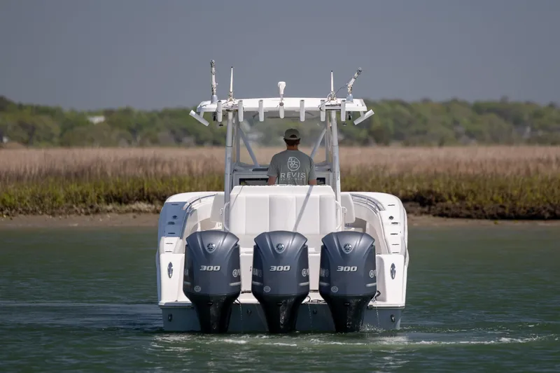 Slide: The Image of 2019 Invincible 36 Open Fisherman boat with triple Yamaha 300 engines on water. - 7