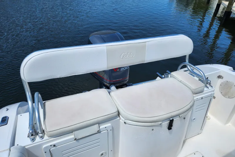 Slide: The Image of 2001 Cobia 234 Center Console boat with Yamaha V6 engine on calm water. - 13