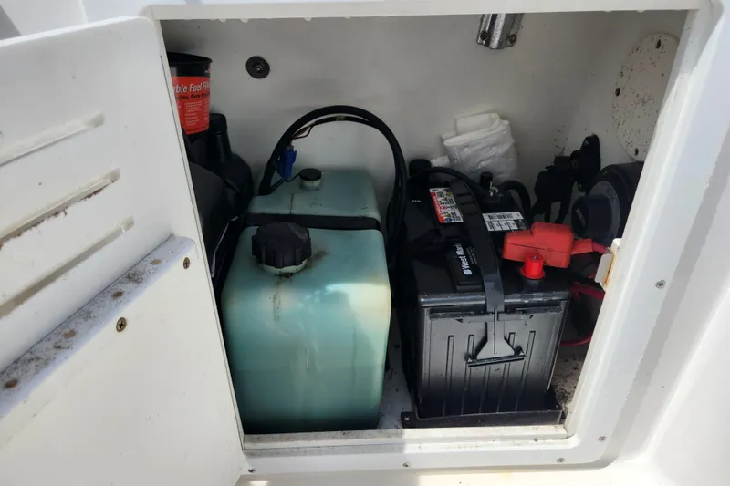 Slide: The Image of Battery and fuel system inside a 2001 Cobia 234 Center Console boat compartment. - 14