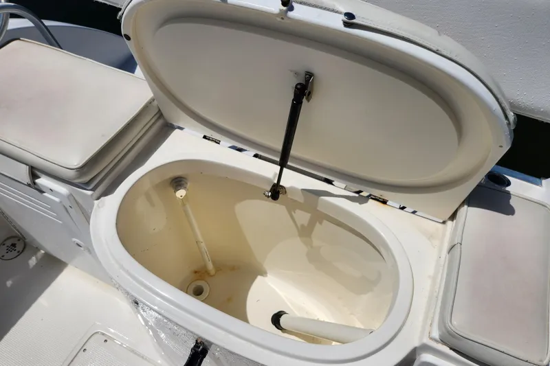 Slide: The Image of Open storage compartment on 2001 Cobia 234 Center Console boat. - 16