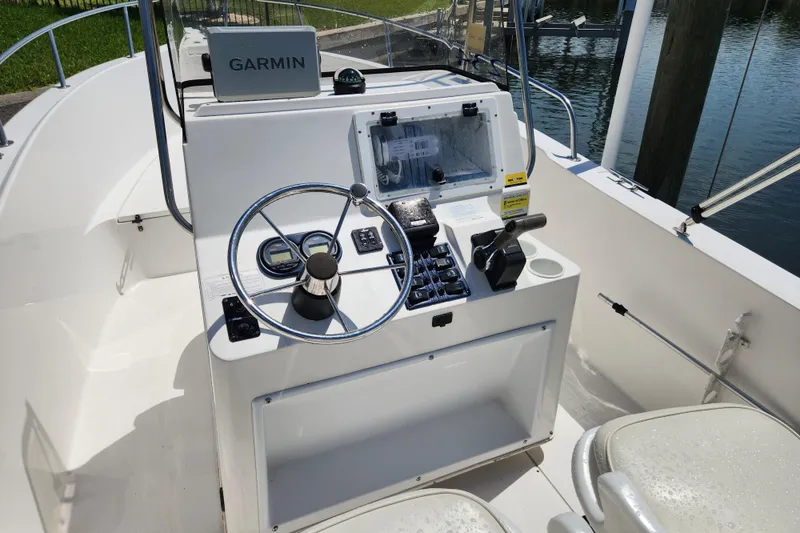 Slide: The Image of 2001 Cobia 234 Center Console boat helm with Garmin navigation system. - 17