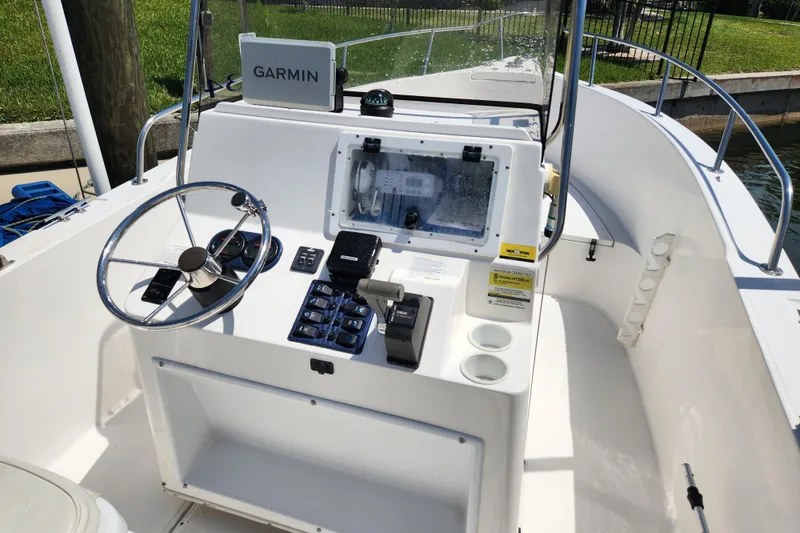 Slide: The Image of Center console of a 2001 Cobia 234 boat with Garmin navigation system. - 18