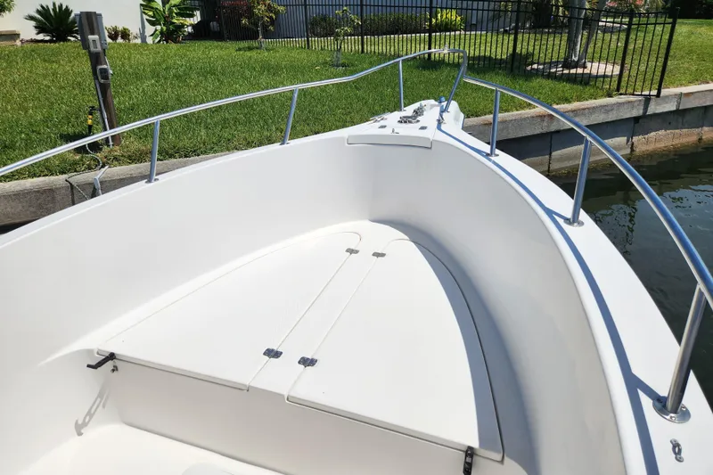 Slide: The Image of 2001 Cobia 234 Center Console boat bow with white deck and railing. - 22