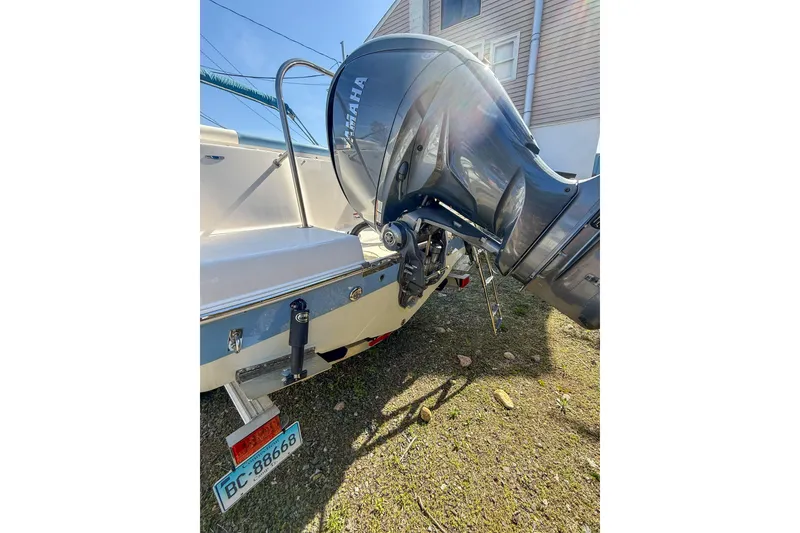 Slide: The Image of 2022 Robalo R227 Dual Console boat with Yamaha outboard motor, parked outdoors. - 11