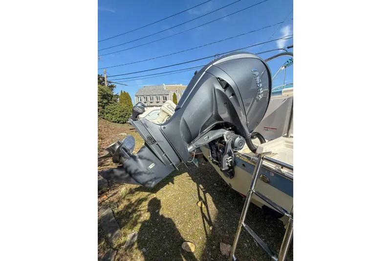 Slide: The Image of 2022 Robalo R227 Dual Console boat with outboard motor, parked outdoors. - 12