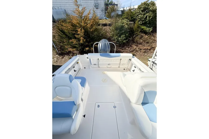 Slide: The Image of 2022 Robalo R227 Dual Console boat interior with white and blue seating. - 17