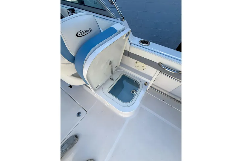 Slide: The Image of 2022 Robalo R227 Dual Console boat interior with open storage compartment. - 19
