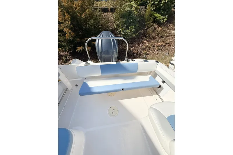 Slide: The Image of 2022 Robalo R227 Dual Console boat interior with seating and outboard motor. - 20